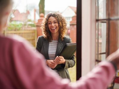 Social worker smiling by door